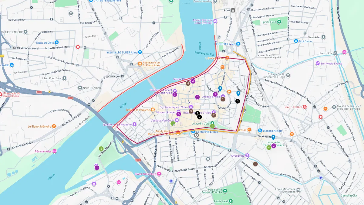 Tourist map of Arles, France showing the historic city center outlined beside the Rhône River. The Arles tourist map highlights major landmarks, walking routes, bridges, museums, and streets with markers across the old town and surrounding neighborhoods.