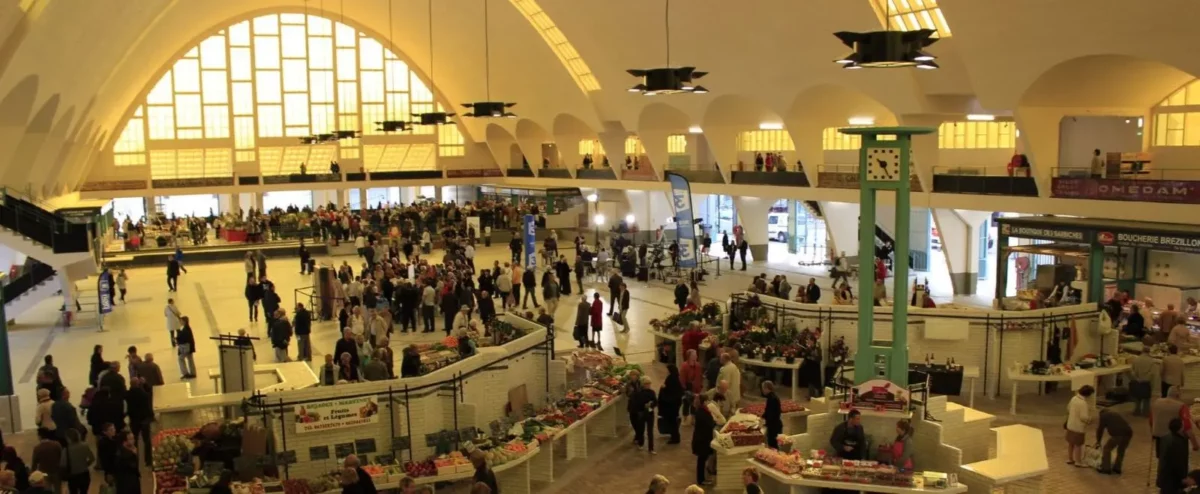 Vibrant Boulingrin Food Market in Reims filled with locals and tourists, offering a taste of local life and cuisine.