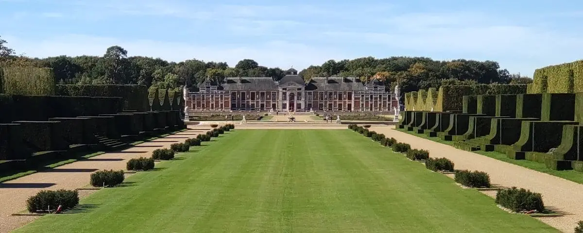 Majestic view of Chateau Champ de Bataille with its manicured gardens, symmetrical pathways, and grand château in the background.