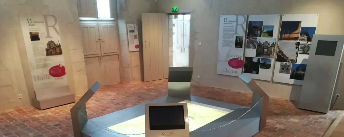 The interior of Espace Richelieu, an exhibition space with informational panels and interactive displays about the local history and architecture.