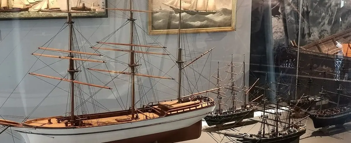 A display of model ships and maritime artifacts at the Fisheries Museum in Fécamp, highlighting the town's nautical heritage.