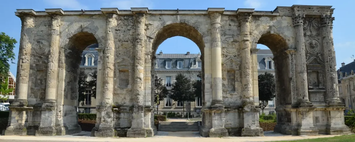 The majestic Mars Gate in Reims, a relic of Roman triumphal architecture, stands as a testament to the city's ancient past.