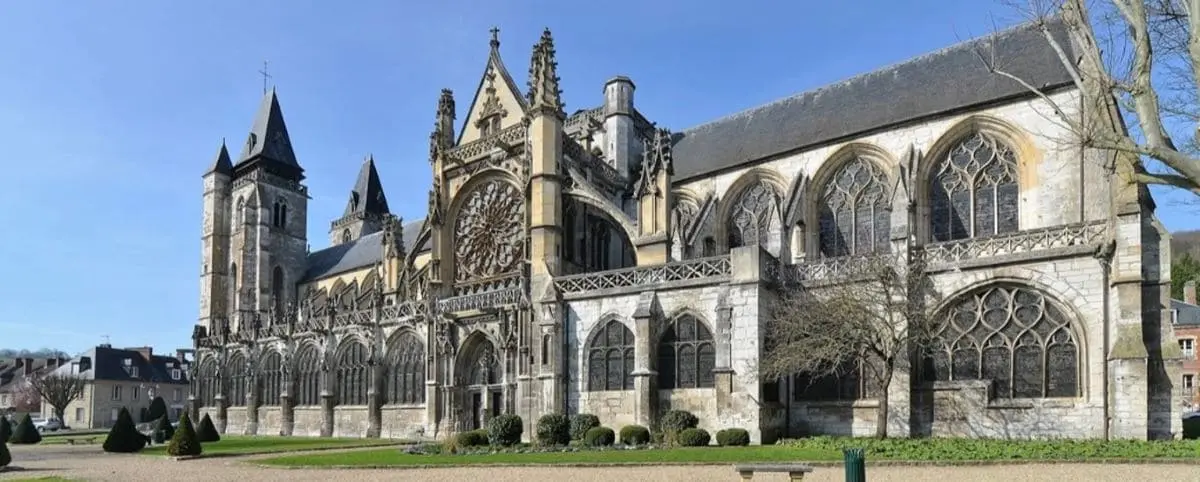 A detailed exterior view of the Notre Dame Church, showcasing its Gothic architectural elements, including ornate stone carvings and stained glass windows.