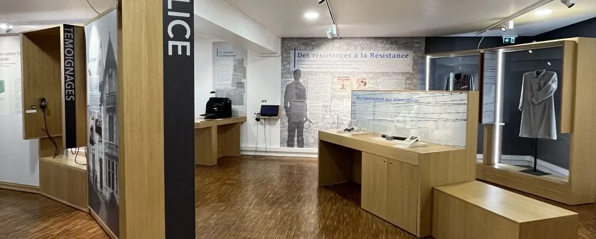 A museum exhibit dedicated to the resistance and deportation during WWII, featuring informative panels, historical artifacts, and displays.