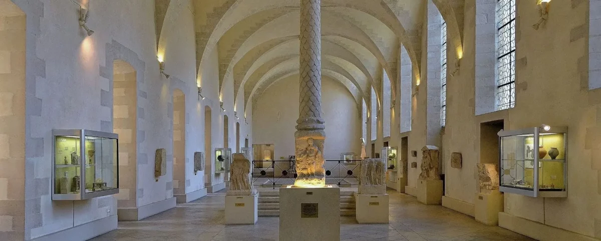 Interior of Saint Remi's Museum in Reims with vaulted ceilings and exhibits displaying the region's history.