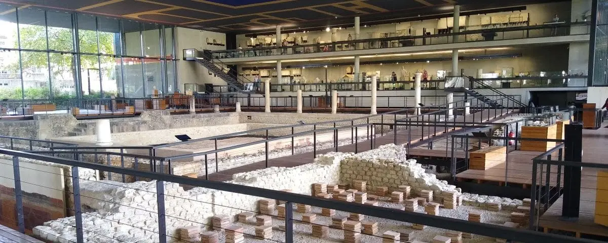 The interior of the Vesunna Museum, displaying ancient Roman ruins and artifacts. The museum's modern architecture contrasts with the historical exhibits, providing a unique viewing experience.