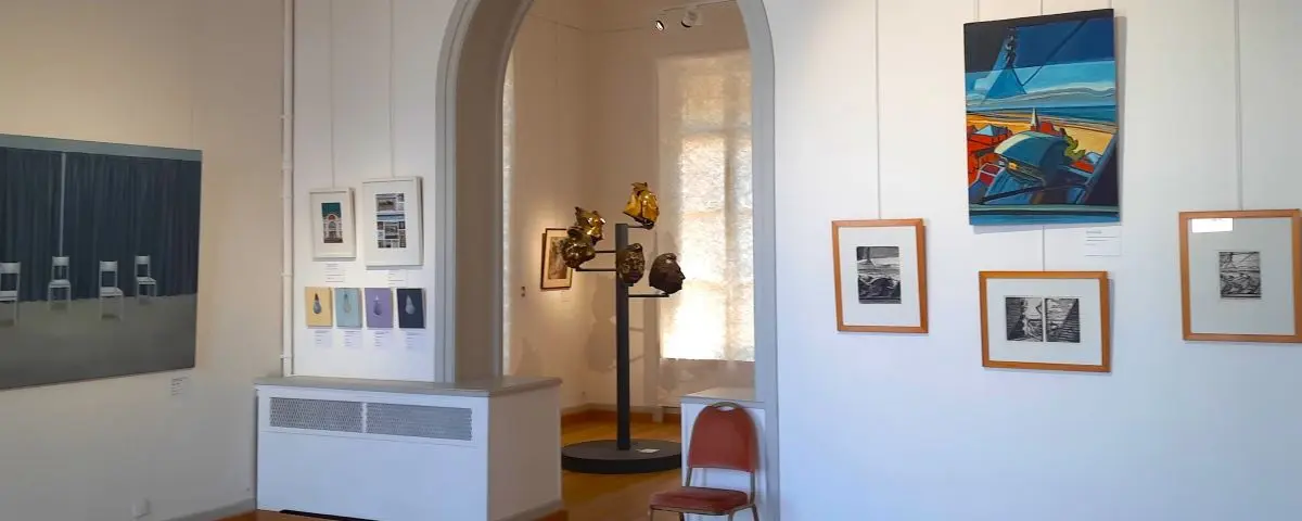 An interior view of the Villa Montebello museum in Trouville, displaying various artworks and sculptures in a well-lit room with white walls and a mix of modern and classical decor.